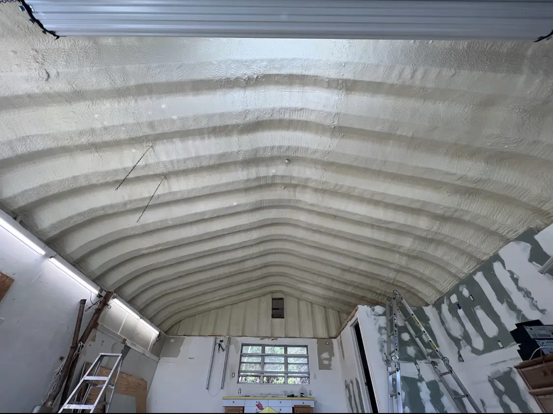 Spray polyurethane foam applied to the underside of a metal roof deck in Leesville
